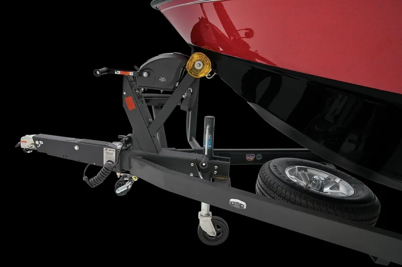 Slide: The Image of Man storing gear in 2026 Ranger 1850MS boat compartment on water. - 13