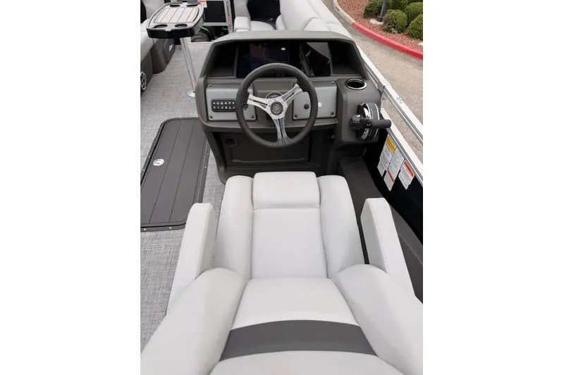 Slide: The Image of 2026 Sun Tracker SportFish 22 XP3 boat interior with steering console and seating. - 11