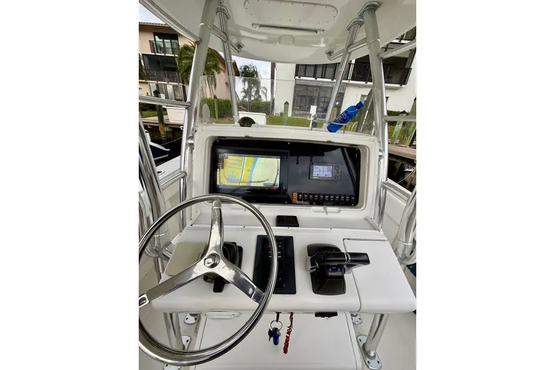 Slide: The Image of 2005 Jupiter 31 Center Console boat dashboard with steering wheel and navigation system. - 10