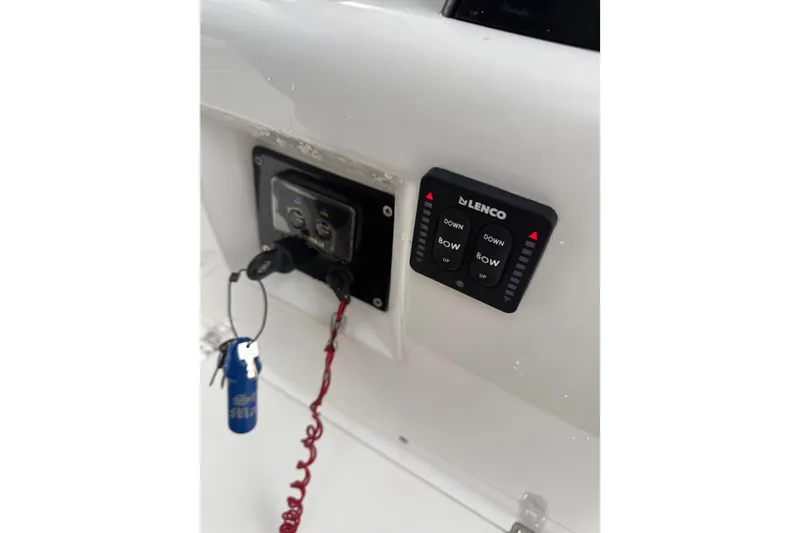Slide: The Image of Control panel on a 2005 Jupiter 31 Center Console boat with Lenco trim tab switches. - 11
