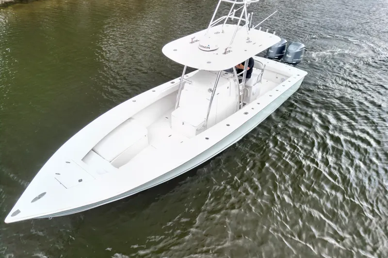 Slide: The Image of 2005 Jupiter 31 Center Console boat cruising on water, aerial view. - 17