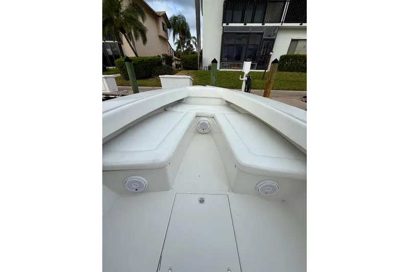 Slide: The Image of 2005 Jupiter 31 Center Console boat interior with white seating and speakers. - 19