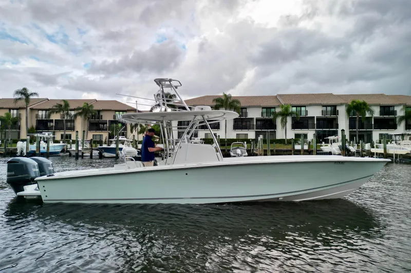 Slide: The Image of 2005 Jupiter 31 Center Console boat docked near waterfront homes. - 3