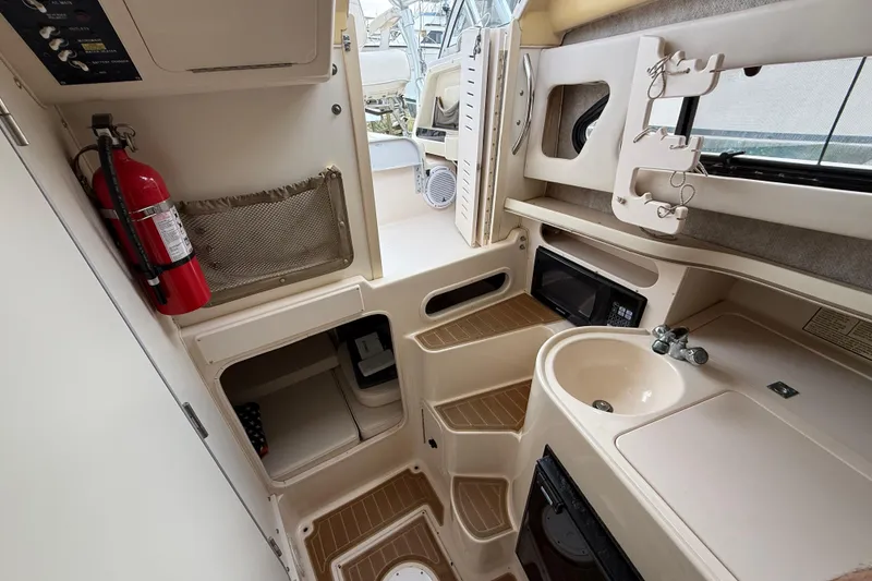 Slide: The Image of 2002 Grady-White Sailfish 282 interior, featuring a step, speaker, and wiring details. - 10