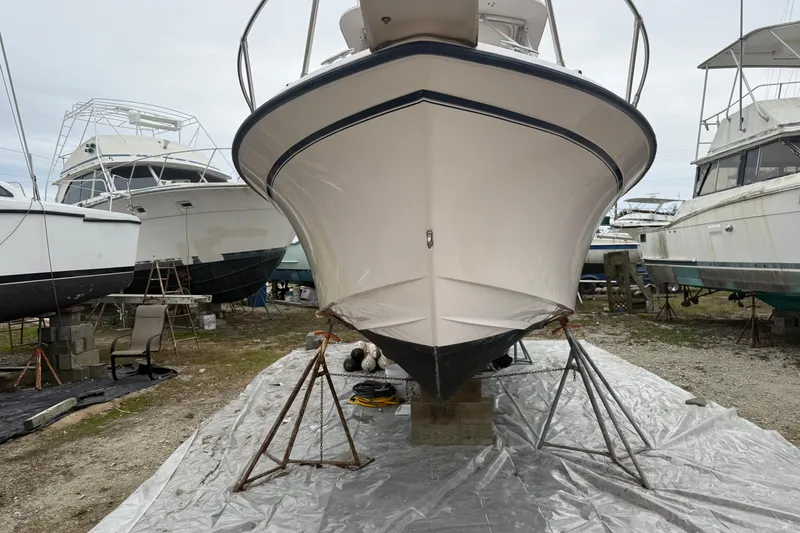 Slide: The Image of 2002 Grady-White Sailfish 282 cabin interior with sink, seating, and table. - 12