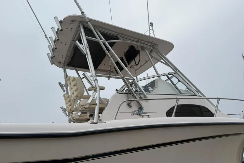 Slide: The Image of 2002 Grady-White Sailfish 282 cabin interior with seating and table setup. - 13