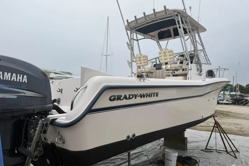 Slide: The Image of 2002 Grady-White Sailfish 282 cabin interior with cushions and table. - 14