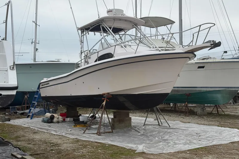 Slide: The Image of 2002 Grady-White Sailfish 282 cabin interior with beige cushions and table. - 15