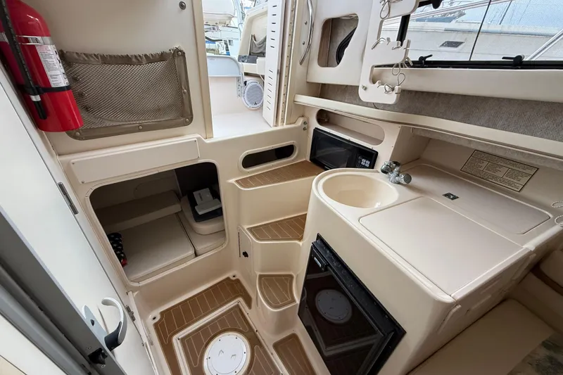 Slide: The Image of 2002 Grady-White Sailfish 282 boat bathroom with toilet, sink, and window. - 17