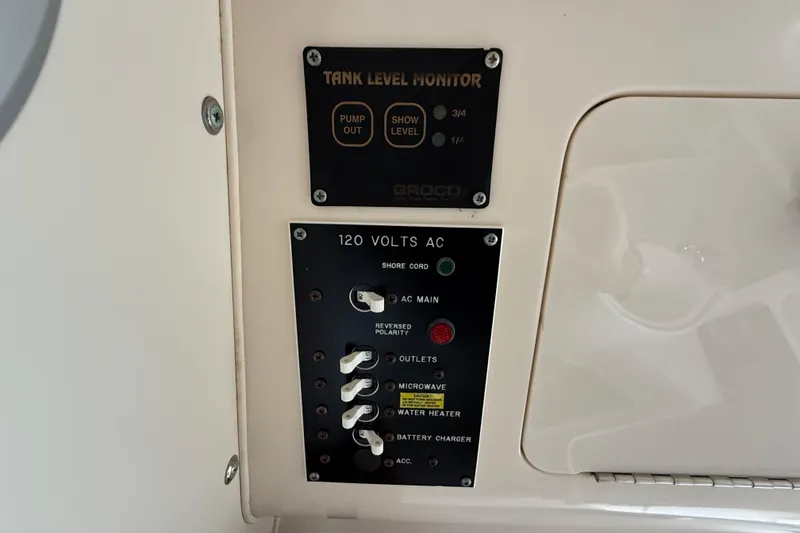 Slide: The Image of 2002 Grady-White Sailfish 282 boat interior with seating and speaker, docked beside another vessel. - 20