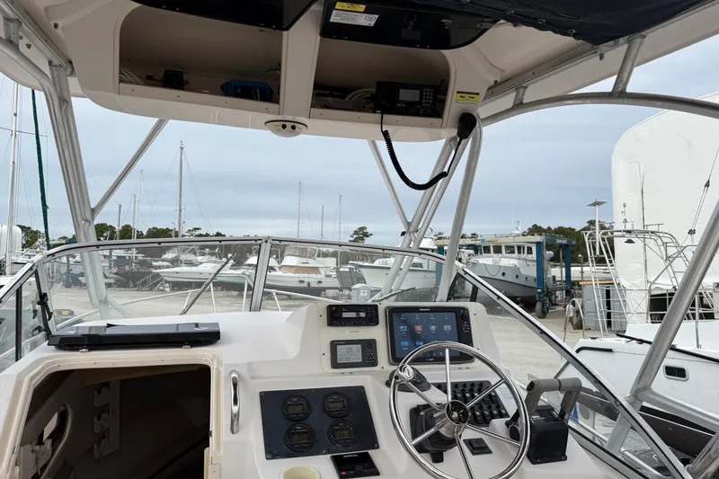 Slide: The Image of 2002 Grady-White Sailfish 282 boat on stands, outdoor storage, clear sky background. - 25