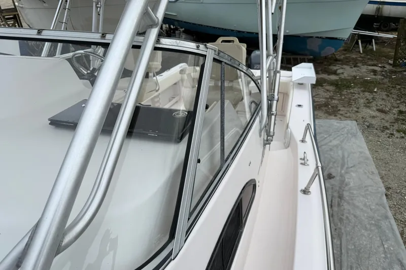 Slide: The Image of 2002 Grady-White Sailfish 282 boat on stands, side view, clear sky background. - 27