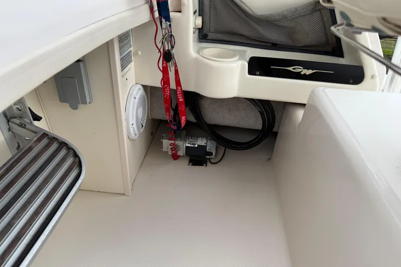 Slide: The Image of 2002 Grady-White Sailfish 282 boat on stands in a marina under clear blue sky. - 36