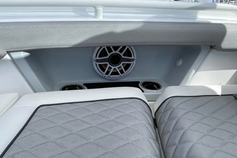 Slide: The Image of 2026 Everglades 367 CX boat interior with speaker and cushioned seating. - 11