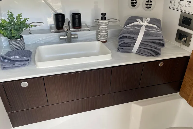 Slide: The Image of Modern bathroom sink in 2026 Everglades 367 CX boat, featuring sleek design and accessories. - 12