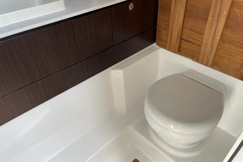 Slide: The Image of Modern bathroom interior of 2026 Everglades 367 CX boat with sleek wood paneling. - 13
