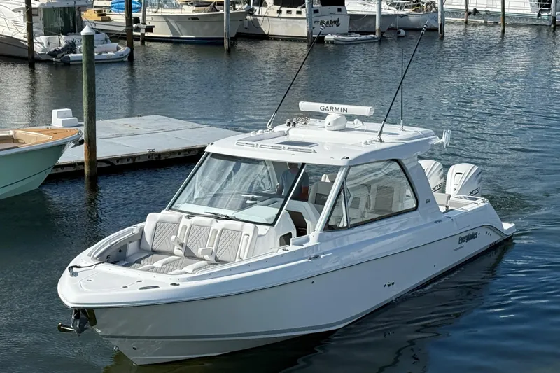 Slide: The Image of 2026 Everglades 367 CX boat docked in marina, featuring sleek design and modern amenities. - 16
