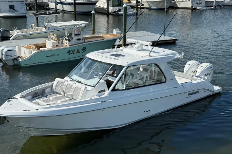 Slide: The Image of 2026 Everglades 367 CX boat docked in marina, featuring sleek design and twin engines. - 17