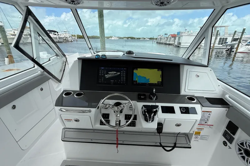 Slide: The Image of Interior view of 2026 Everglades 367 CX boat cockpit with navigation screens and steering wheel. - 19