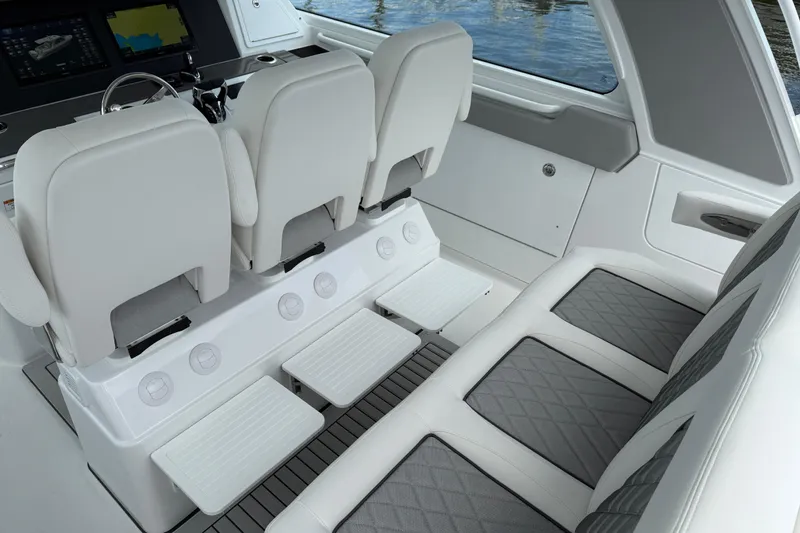 Slide: The Image of 2026 Everglades 367 CX boat interior with luxurious seating and modern dashboard. - 21