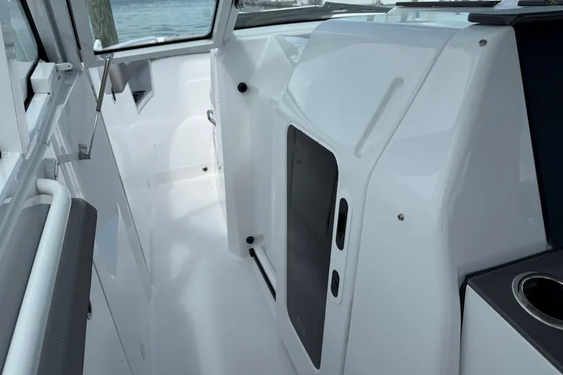 Slide: The Image of Interior view of 2026 Everglades 367 CX boat, showcasing sleek white design and modern features. - 23