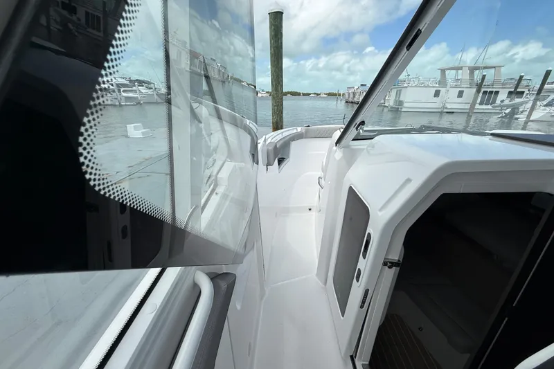 Slide: The Image of 2026 Everglades 367 CX boat docked, showcasing sleek design and spacious deck area. - 24