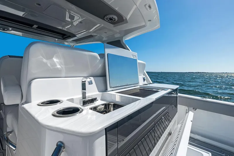 Slide: The Image of Manufacturer Provided Image: Luxury outdoor kitchen on 2025 Everglades 367 CX boat, ocean view, sunny day. - 28