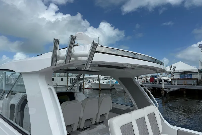 Slide: The Image of 2026 Everglades 367 CX boat docked, showcasing sleek design and spacious seating. - 29