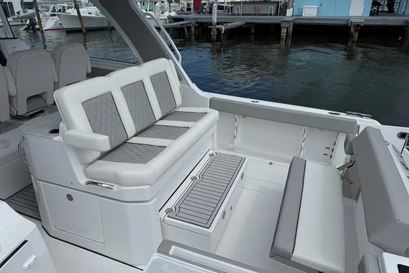 Slide: The Image of Luxurious seating area on the 2026 Everglades 367 CX boat, docked by the water. - 30