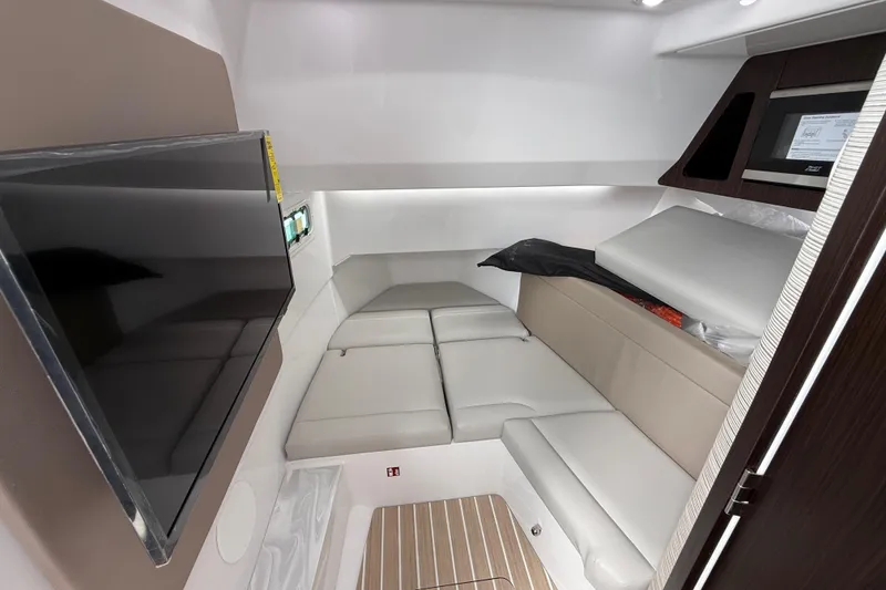 Slide: The Image of 2026 Everglades 367 CX cabin interior with modern seating and mounted TV. - 38