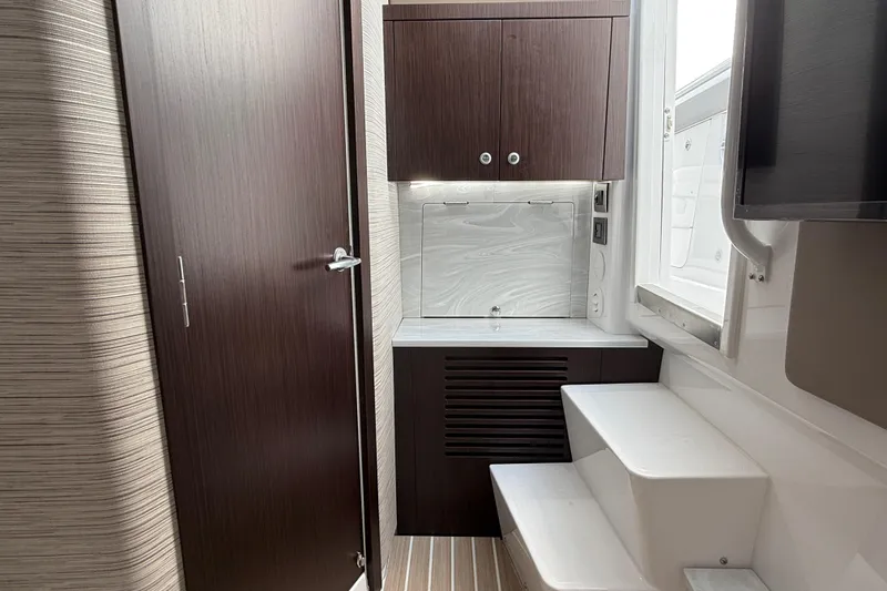 Slide: The Image of Interior of 2026 Everglades 367 CX boat with modern cabinetry and steps. - 41