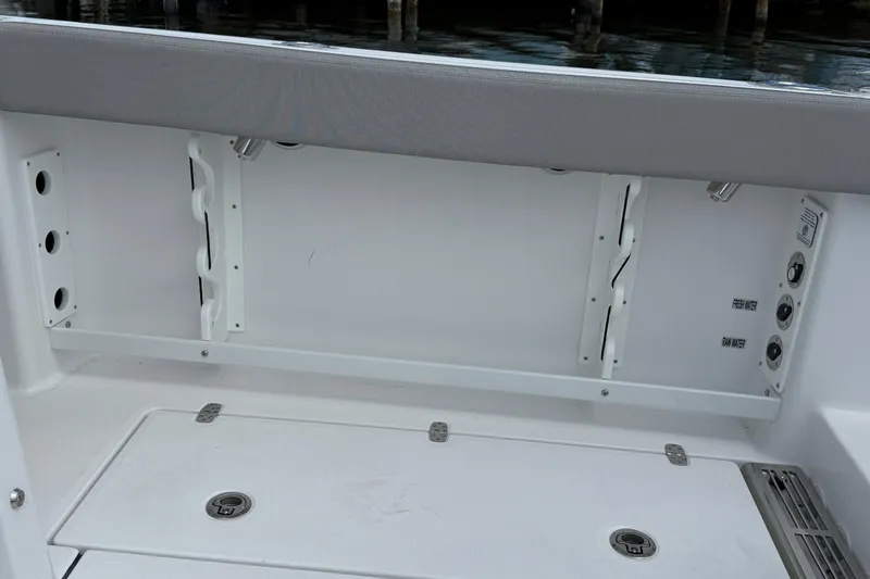 Slide: The Image of 2026 Everglades 367 CX boat interior with storage compartments and water access points. - 50