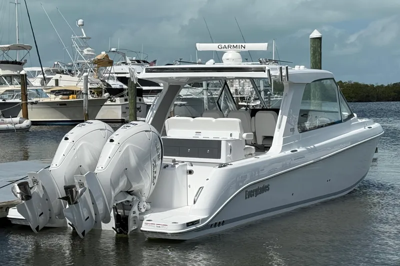 Slide: The Image of 2026 Everglades 367 CX boat docked with twin outboard engines. - 54