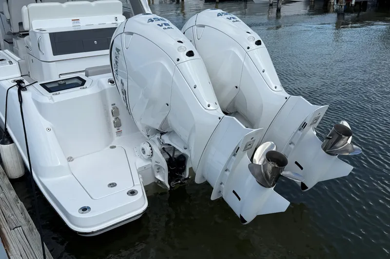 Slide: The Image of 2026 Everglades 367 CX boat with dual outboard engines docked in water. - 55