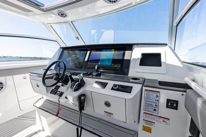 Slide: The Image of Helm of 2026 Everglades 367 CX boat with advanced navigation displays and controls. - 7