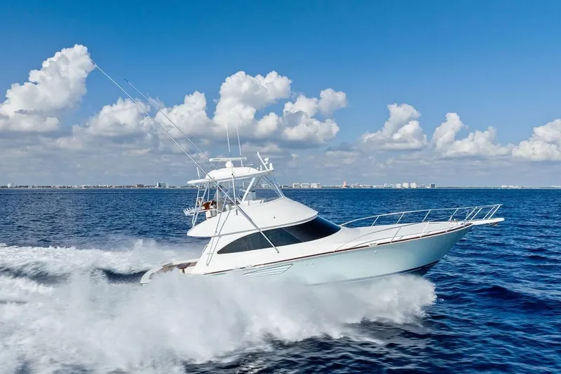 Slide: The Image of 2022 Viking 48 Convertible yacht cruising on open ocean under blue sky. - 17