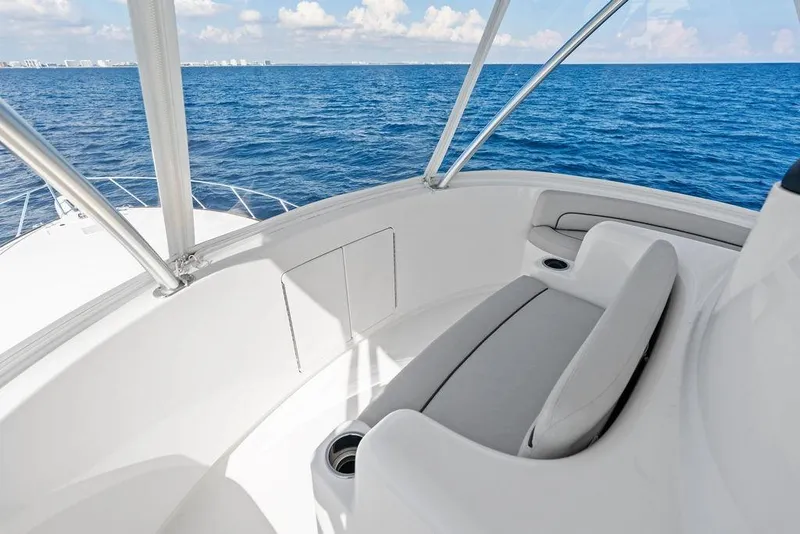Slide: The Image of 2022 Viking 48 Convertible yacht interior with ocean view, featuring sleek seating. - 23
