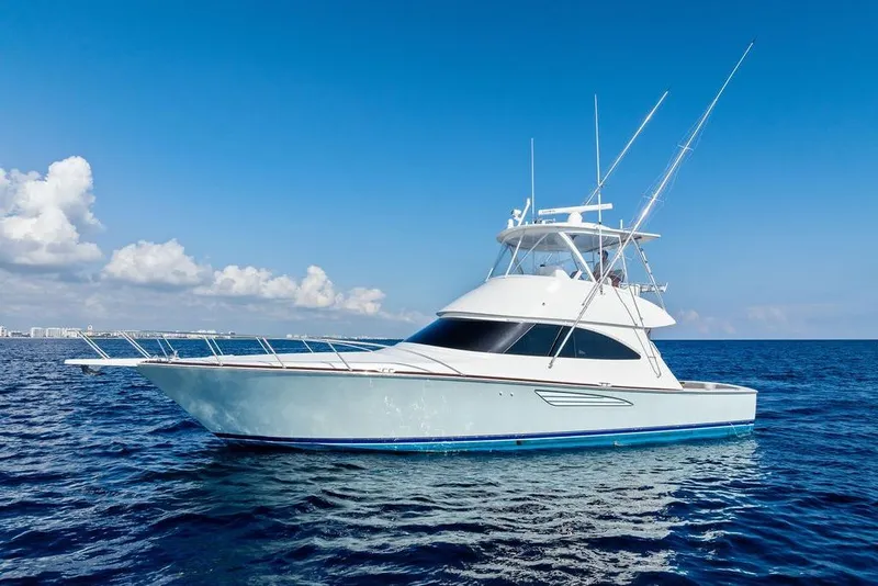 Slide: The Image of 2022 Viking 48 Convertible yacht on open sea under clear blue sky. - 4