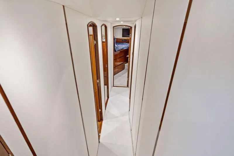Slide: The Image of Interior hallway of 2022 Viking 48 Convertible yacht, featuring sleek design and wood accents. - 49