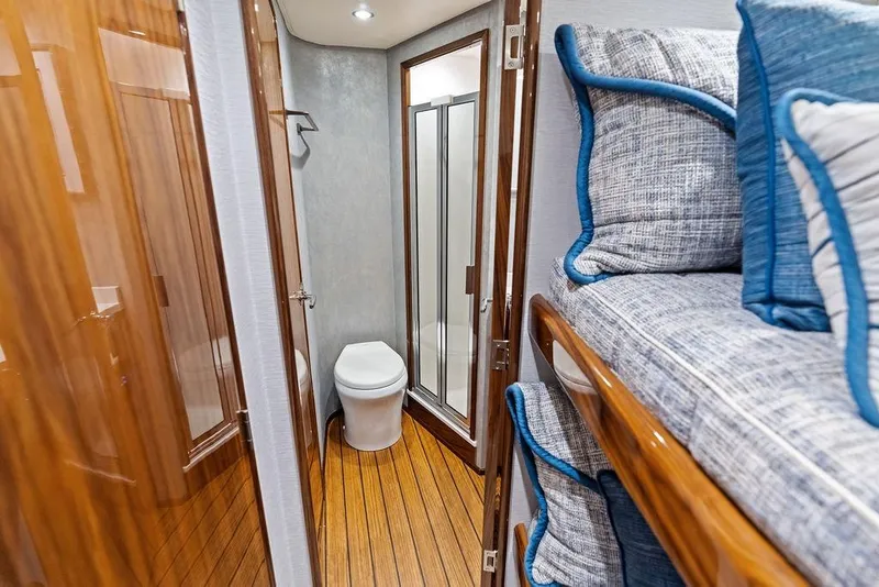 Slide: The Image of Interior of 2022 Viking 48 Convertible yacht with bunk beds and bathroom. - 61