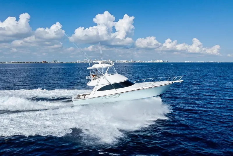 Slide: The Image of 2022 Viking 48 Convertible yacht cruising on open ocean under blue sky. - 8