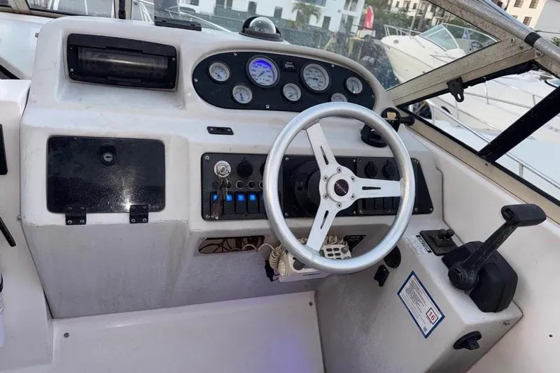 Slide: The Image of 1997 Donzi 275 LXC boat dashboard with steering wheel and control panel. - 3