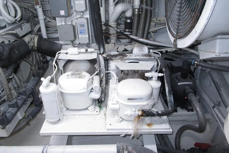 Slide: The Image of Engine room of 1989 Striker 62 yacht with various mechanical components and wiring. - 72