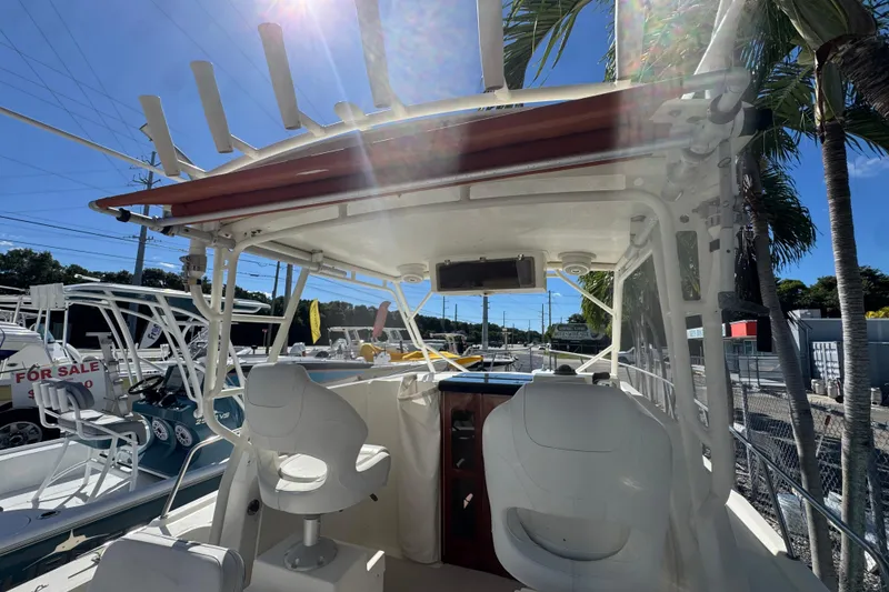 Slide: The Image of 1997 Parker 2510 Walkaround boat interior with seating, under sunny skies. - 5
