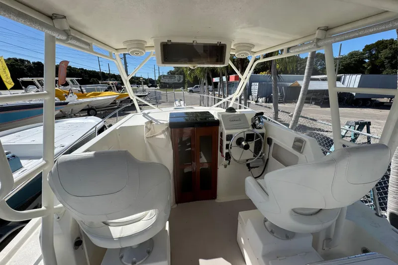 Slide: The Image of 1997 Parker 2510 Walkaround boat interior with helm, seats, and navigation equipment. - 9