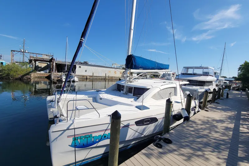 The Image of 2014 Leopard 39 catamaran docked at a marina under a clear blue sky. - 0