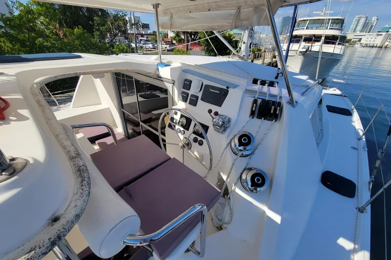 Slide: The Image of Cockpit of 2014 Leopard 39 catamaran with steering wheel and navigation controls. - 11