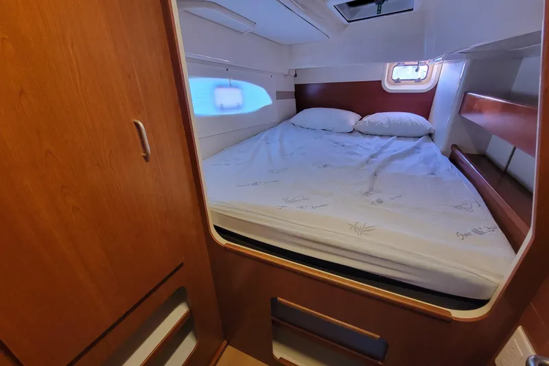 Slide: The Image of Cozy bedroom in 2014 Leopard 39 yacht with wooden cabinetry and natural light. - 4