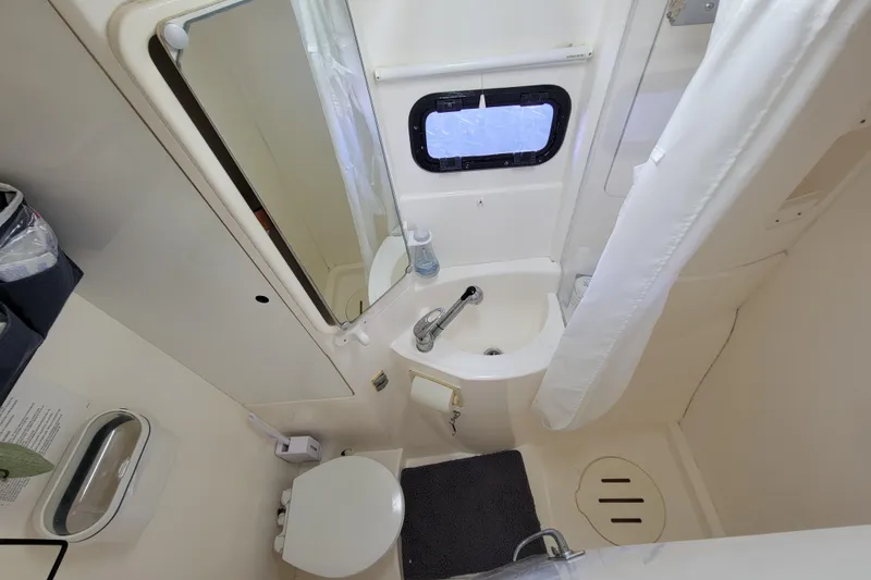 Slide: The Image of Compact bathroom in a 2014 Leopard 39 yacht, featuring a sink, toilet, and shower. - 5