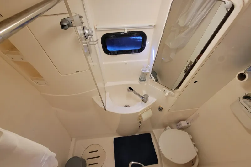 Slide: The Image of Compact bathroom in a 2014 Leopard 39 yacht, featuring sink, toilet, and shower. - 7